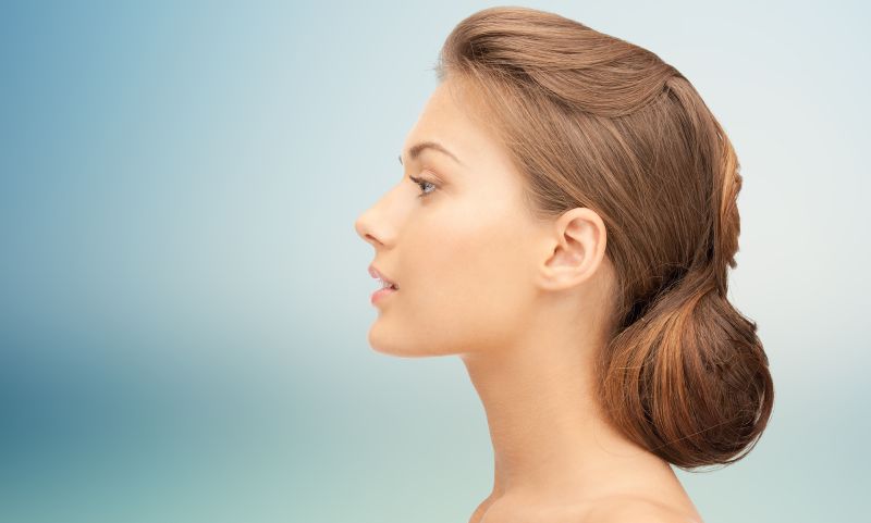 profile of a beautiful young woman after rhinoplasty surgery